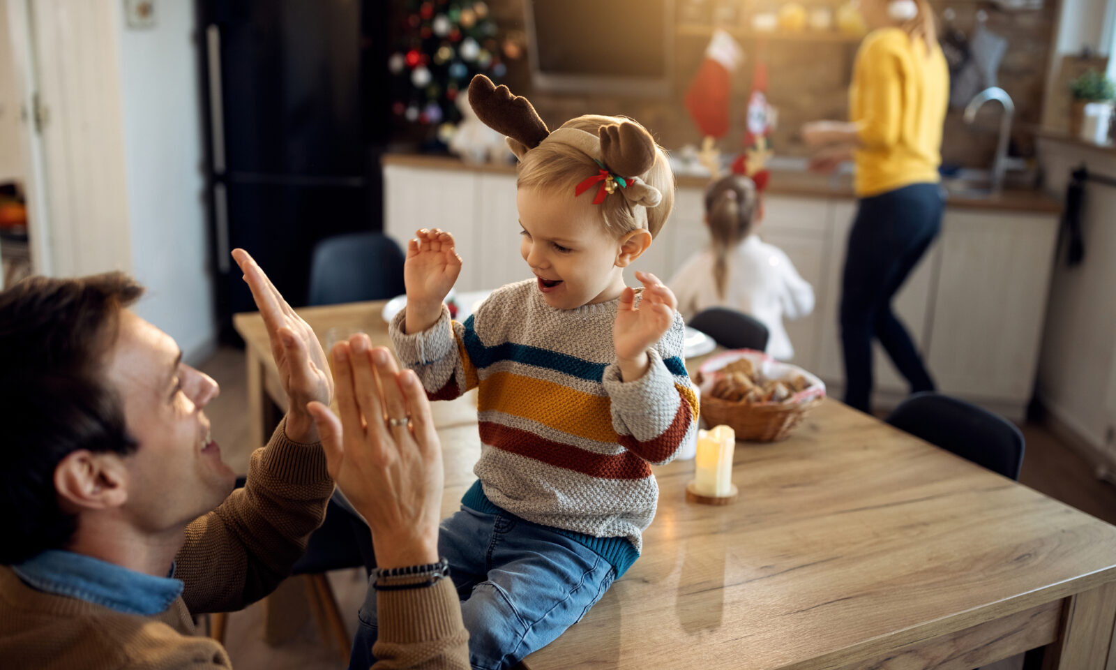 Happy father having fun with his son on Christmas day at home.