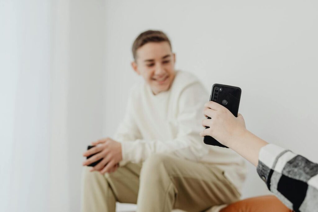 Tinejdžerica pokazuje tinejdžeru sliku na mobitelu